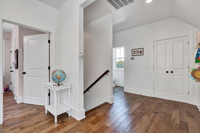 entrance foyer with vaulted ceiling and hardwood / wood-style floors