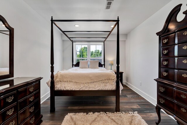 bedroom with dark hardwood / wood-style flooring