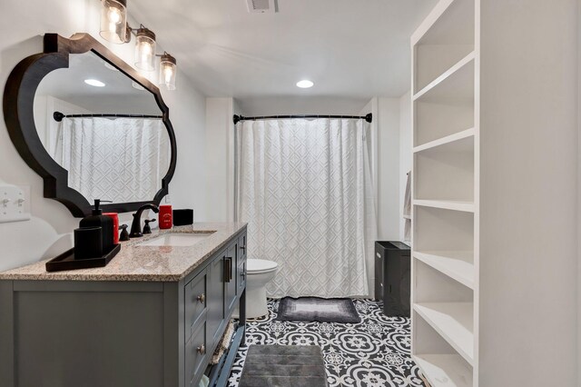 bathroom featuring tile patterned flooring, vanity, toilet, and a shower with shower curtain