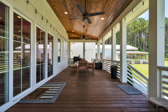 unfurnished sunroom featuring vaulted ceiling, ceiling fan, and wooden ceiling