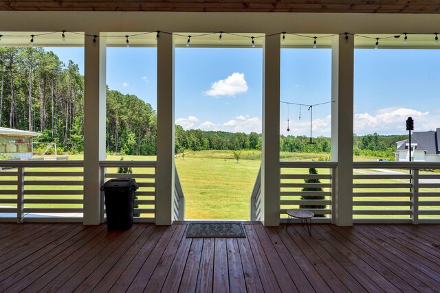 wooden terrace with a yard