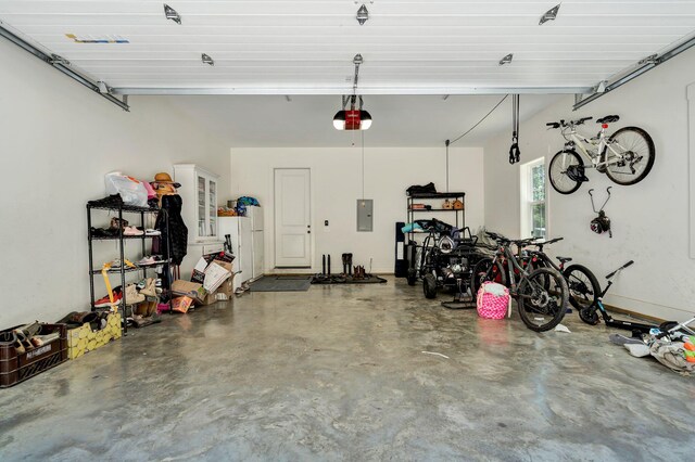 garage with a garage door opener and electric panel