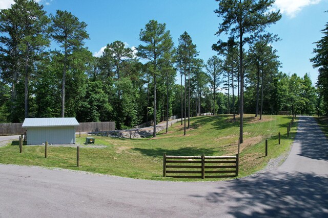 view of community with a yard and an outdoor structure