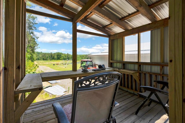 sunroom / solarium featuring vaulted ceiling and a wealth of natural light