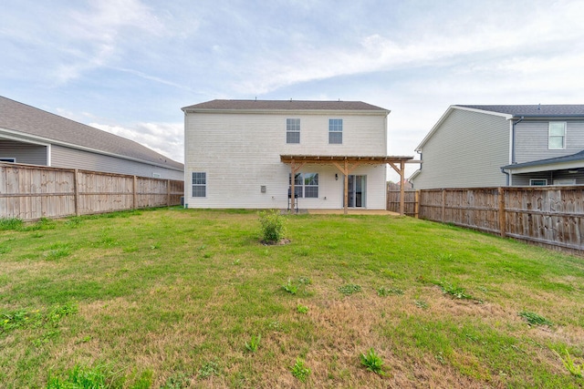 back of house with a yard and a patio area