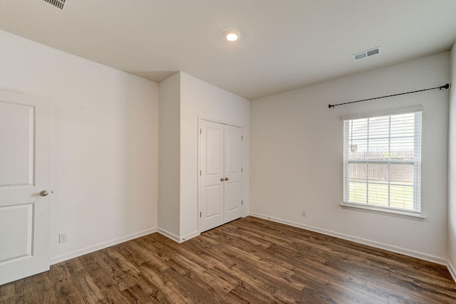 empty room featuring dark wood-type flooring