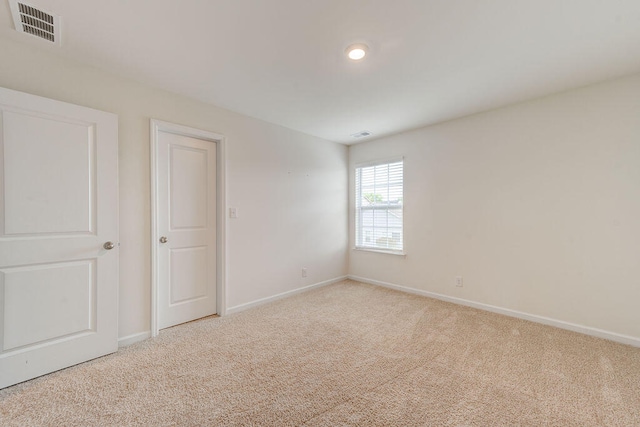 unfurnished bedroom featuring light colored carpet