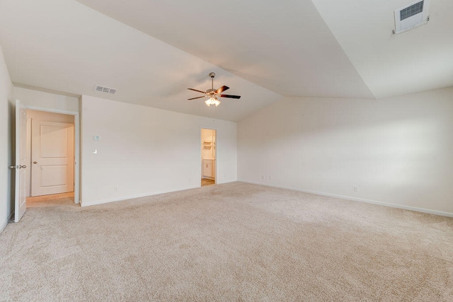 carpeted empty room featuring vaulted ceiling and ceiling fan