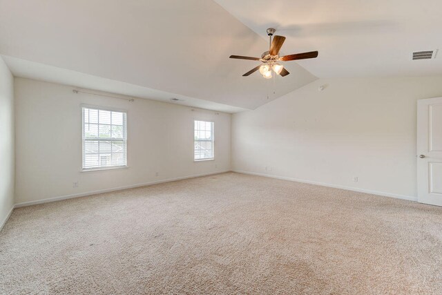 carpeted spare room with lofted ceiling and ceiling fan