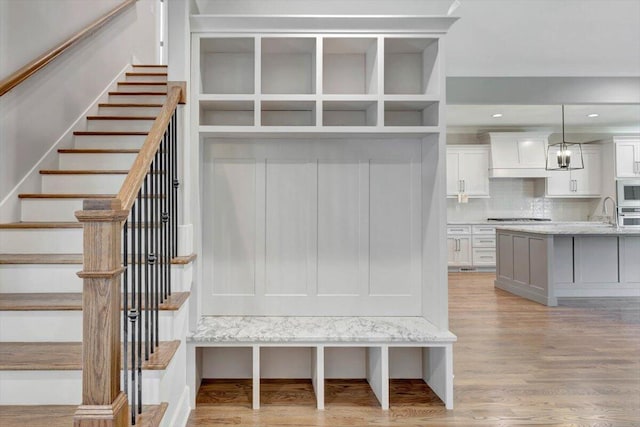 mudroom with light hardwood / wood-style flooring