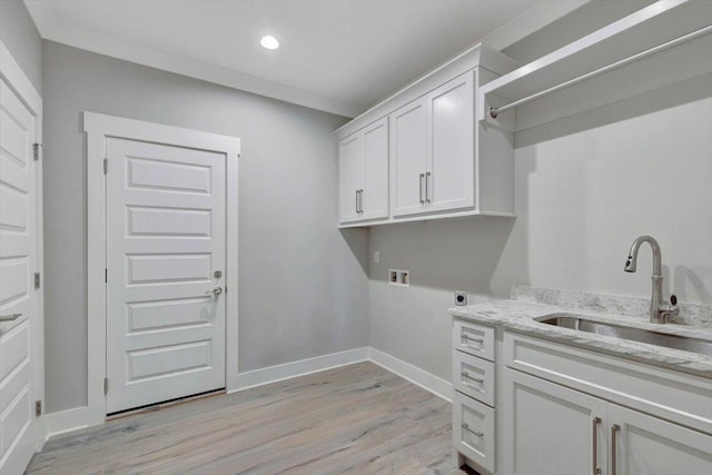 laundry room with hookup for a washing machine, light wood-type flooring, hookup for an electric dryer, sink, and cabinets