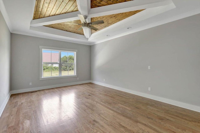 unfurnished room featuring a raised ceiling, wood-type flooring, and ceiling fan