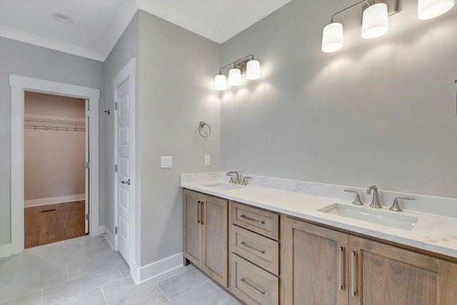 bathroom with crown molding, vanity, and tile patterned floors