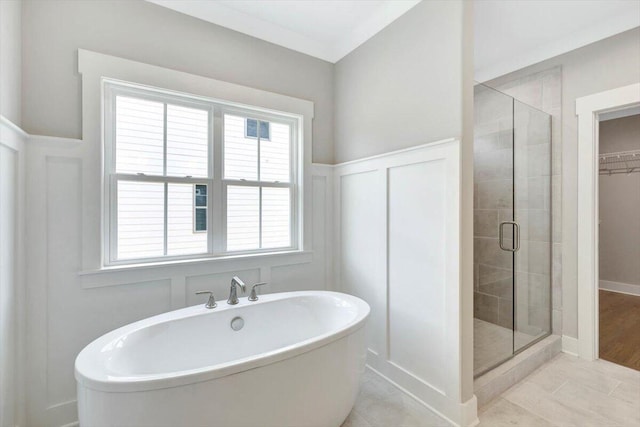 bathroom featuring a healthy amount of sunlight, tile patterned floors, and shower with separate bathtub