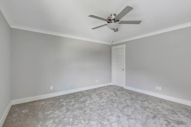 carpeted spare room featuring ceiling fan and ornamental molding