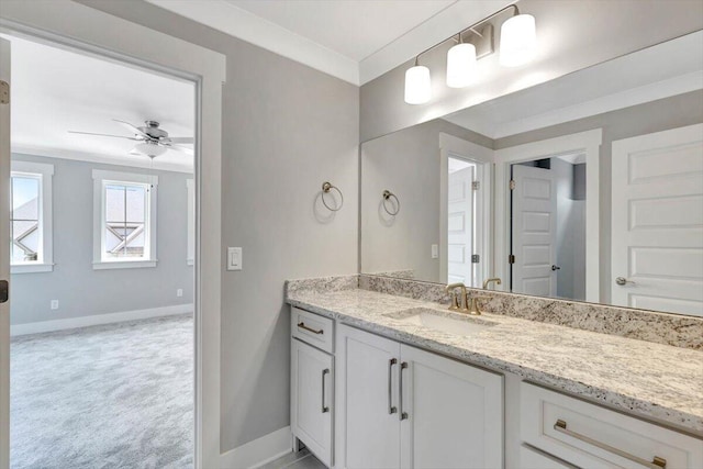 bathroom with ornamental molding, vanity, and ceiling fan