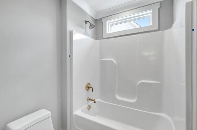 bathroom with bathtub / shower combination and toilet