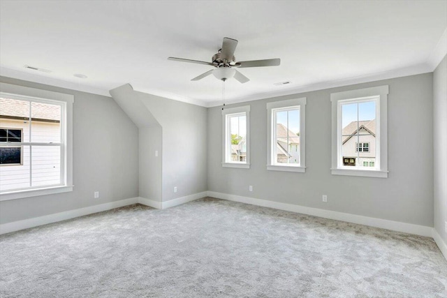 spare room featuring ornamental molding, light colored carpet, and ceiling fan