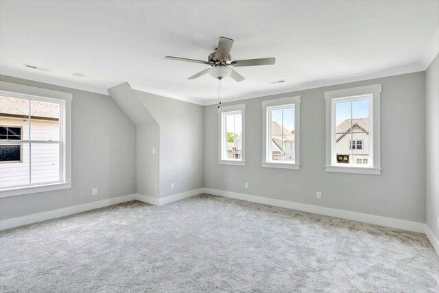 additional living space with baseboards, ceiling fan, and carpet flooring