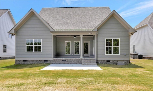 rear view of house featuring cooling unit, ceiling fan, a yard, and a patio area