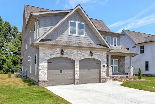 craftsman-style house with a garage and a front lawn