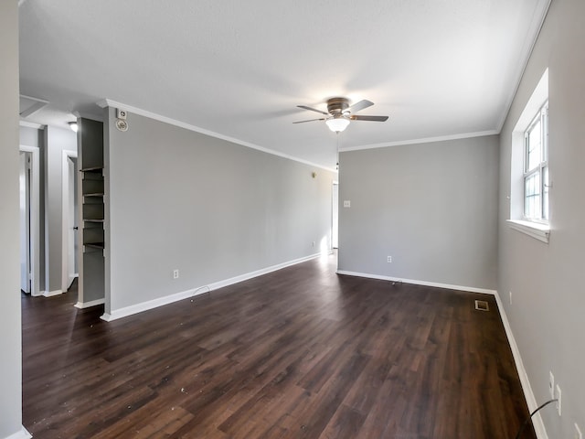 empty room featuring ceiling fan, dark hardwood / wood-style flooring, and ornamental molding