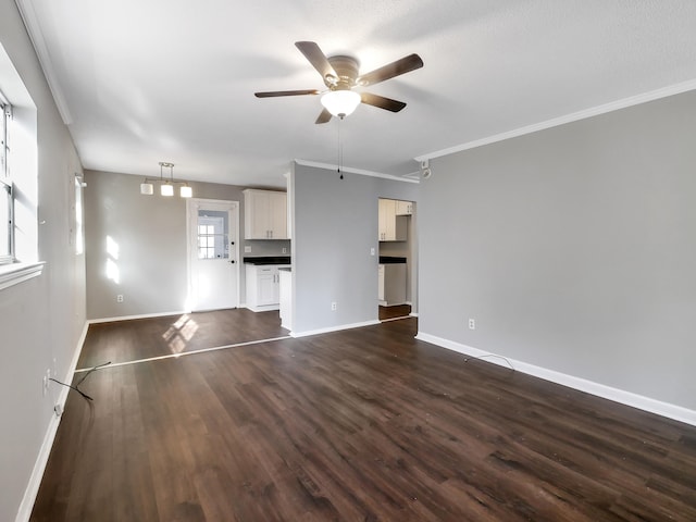 unfurnished living room featuring crown molding, dark wood-type flooring, and ceiling fan