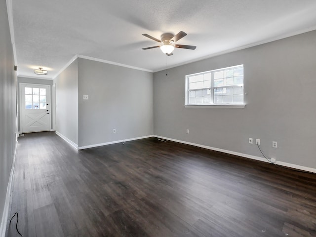 spare room with ornamental molding, ceiling fan, dark hardwood / wood-style floors, and a textured ceiling