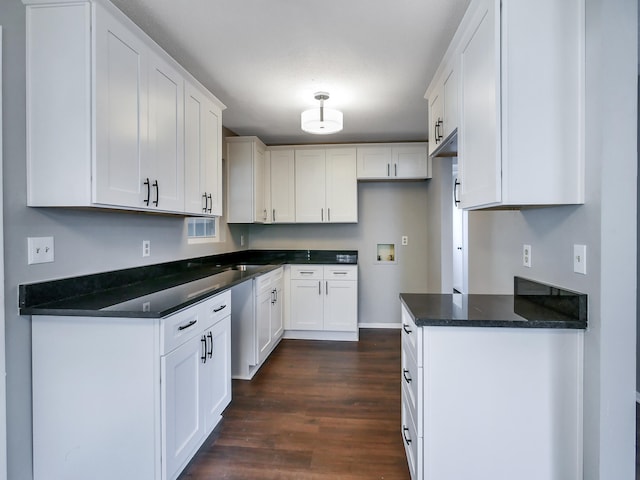 kitchen featuring dark hardwood / wood-style flooring and white cabinets