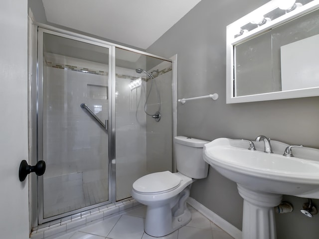 bathroom with tile patterned flooring, toilet, a shower with door, and sink