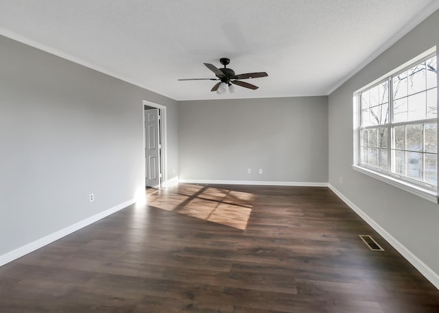 unfurnished room with a textured ceiling, dark wood-type flooring, and ceiling fan