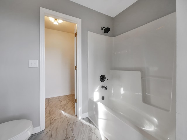 bathroom featuring toilet and shower / bathing tub combination