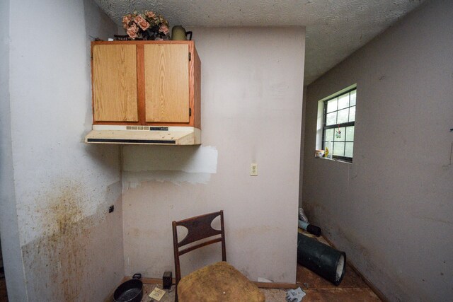 laundry area featuring a textured ceiling