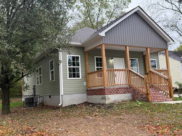 bungalow-style house with central AC and covered porch