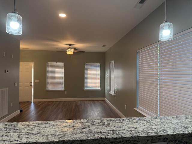 unfurnished room featuring dark wood-type flooring and ceiling fan