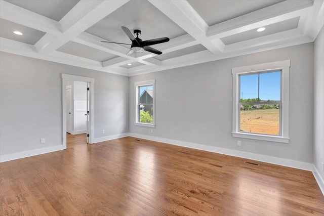 unfurnished room featuring coffered ceiling, hardwood / wood-style floors, ceiling fan, and beamed ceiling