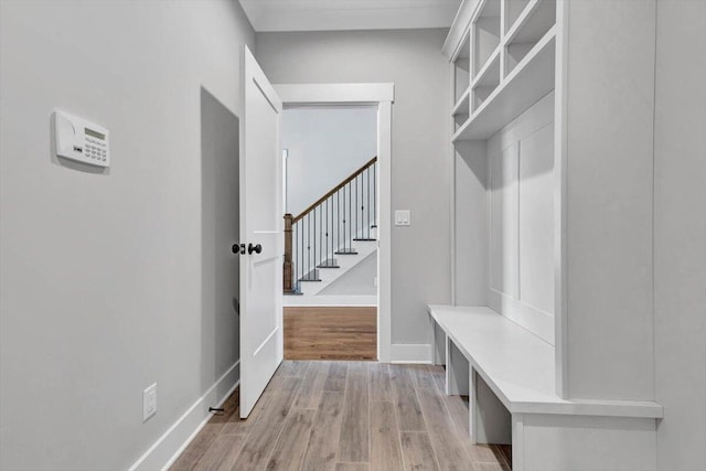 mudroom featuring baseboards and light wood-style flooring