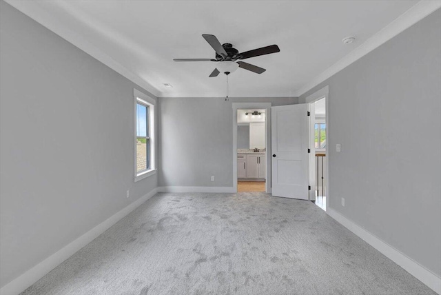 unfurnished bedroom featuring ceiling fan, light colored carpet, and connected bathroom