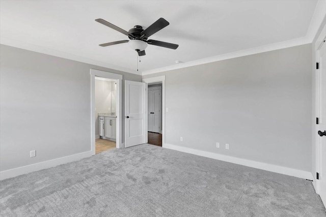 unfurnished bedroom featuring light carpet, ceiling fan, ensuite bathroom, and crown molding