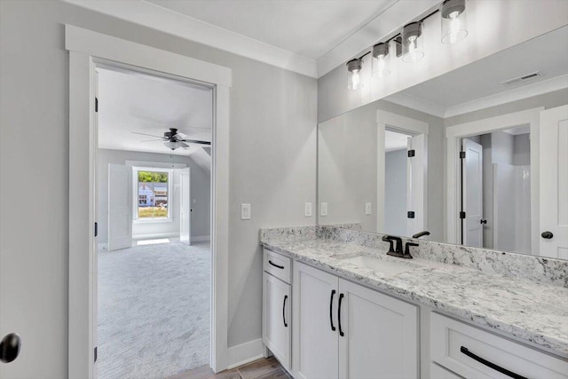 bathroom featuring crown molding, vanity, and ceiling fan