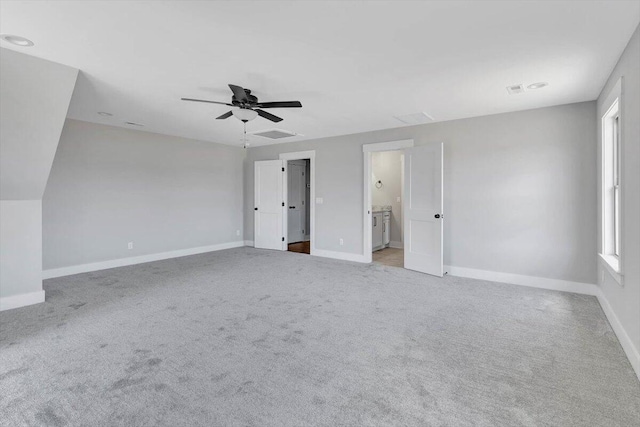 unfurnished bedroom with ceiling fan, connected bathroom, and light carpet