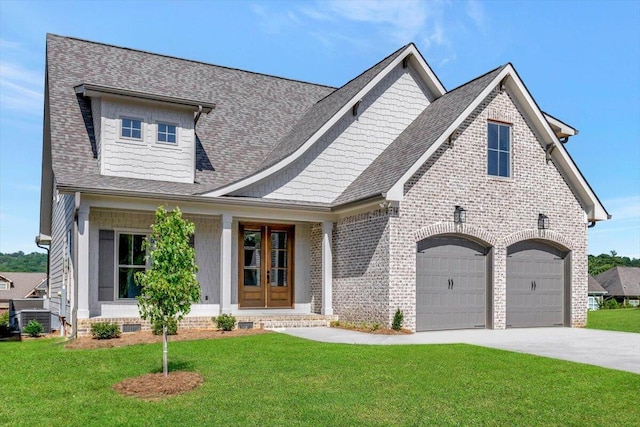 view of front of house with brick siding, a front lawn, roof with shingles, french doors, and driveway