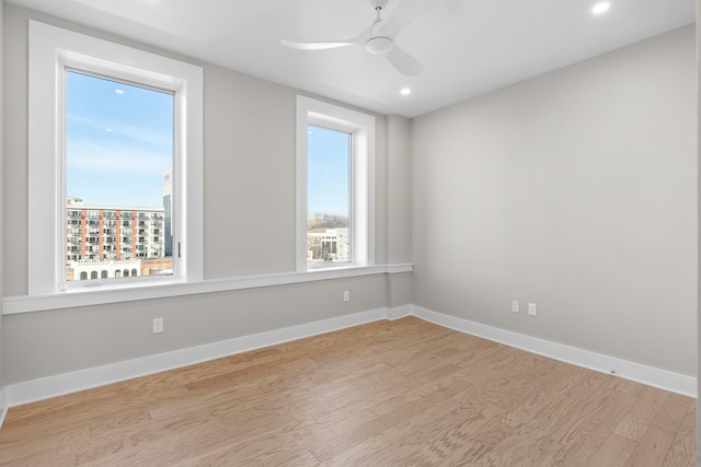 spare room featuring ceiling fan and light hardwood / wood-style flooring