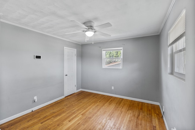 unfurnished room with ceiling fan, light wood-type flooring, and ornamental molding