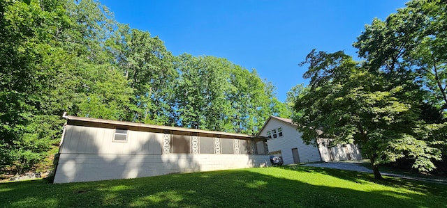 view of side of home featuring a yard