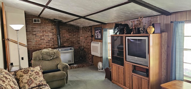 living room with brick wall, a wood stove, carpet, lofted ceiling, and heating unit