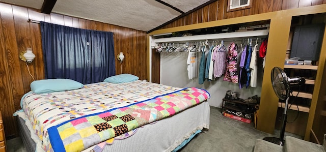 carpeted bedroom featuring a textured ceiling, electric panel, wood walls, and a closet