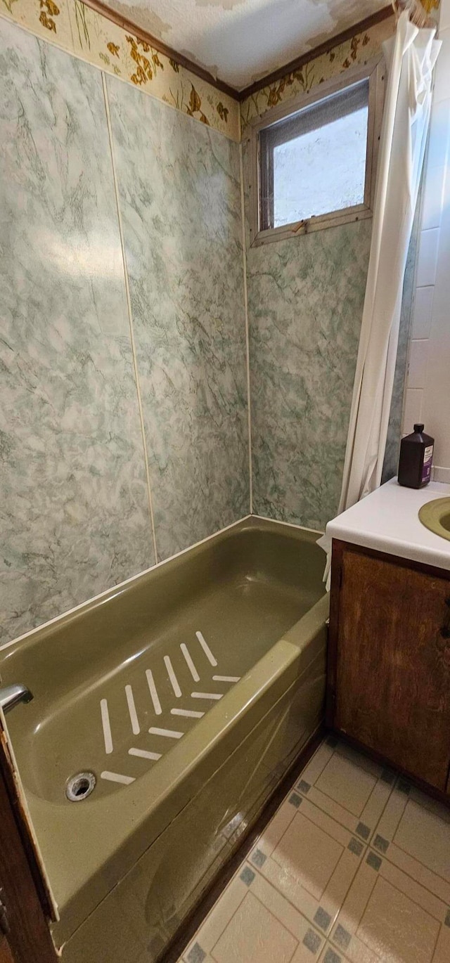 bathroom with shower / bath combo, vanity, a textured ceiling, and tile patterned floors