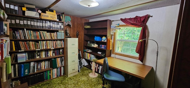 carpeted office featuring a textured ceiling