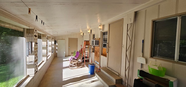 sunroom featuring plenty of natural light and vaulted ceiling